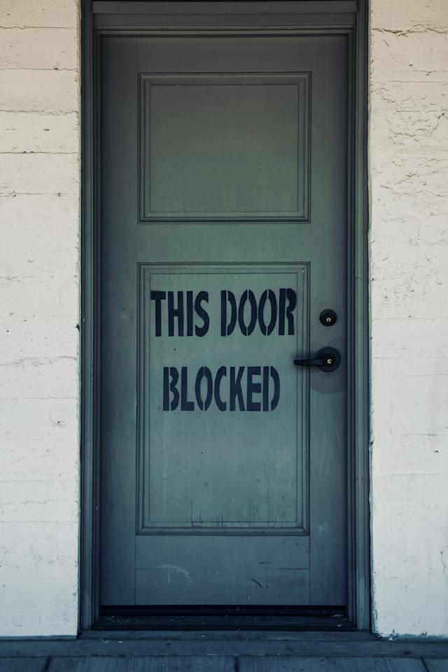 Door with THIS DOOR BLOCKED stenciled on it